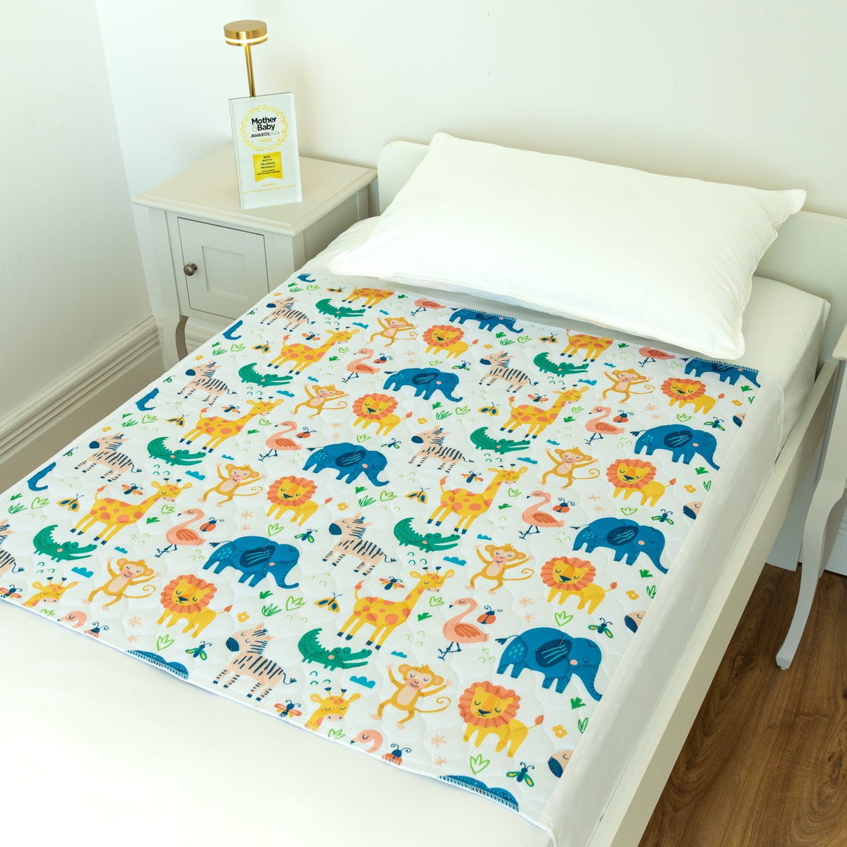 Bedwetz Safari waterproof mattress protector on a single bed with the Mother&Baby Awards 2026 Gold trophy